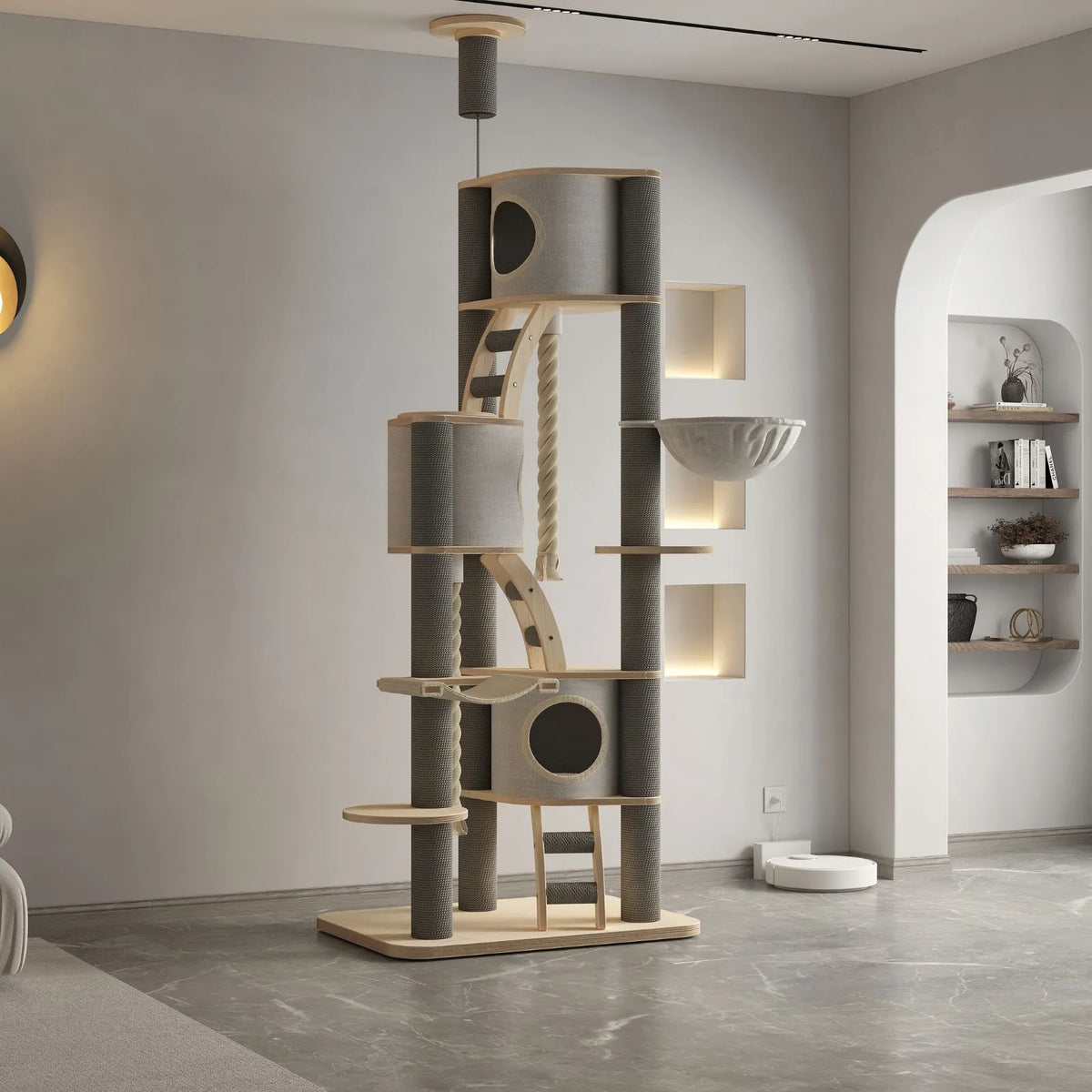 A tall multi-level Petoria Cottage cat tree with light wood and gray fabric panels, shown in a modern minimalist room with gray flooring and built-in shelving.