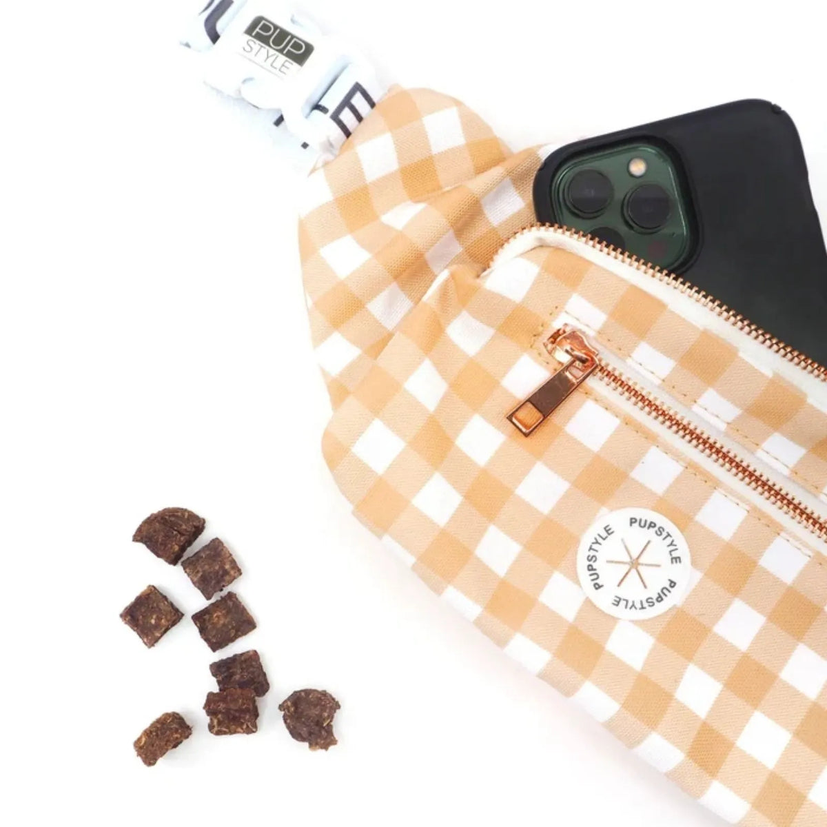 Pupstyle Creme Brulee Dog Parent Bum Bag with adjustable waist strap shown with a black smartphone partially tucked inside and small brown dog treats on a white background.
