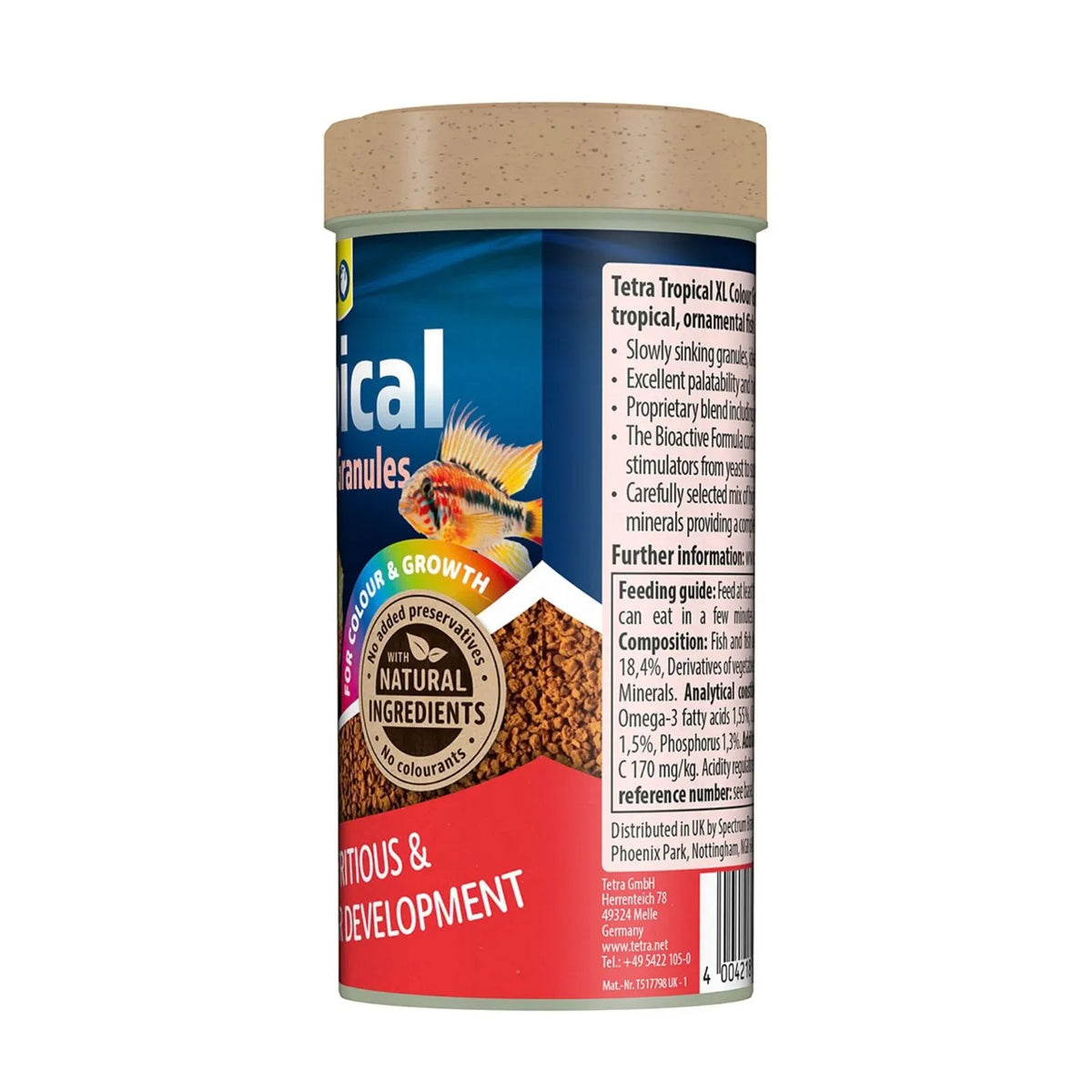 A cylindrical plastic container of Tetra Tropical III fish food granules, showing the side label with product details, a gold seal, and a brown food texture image, topped with a light brown lid.