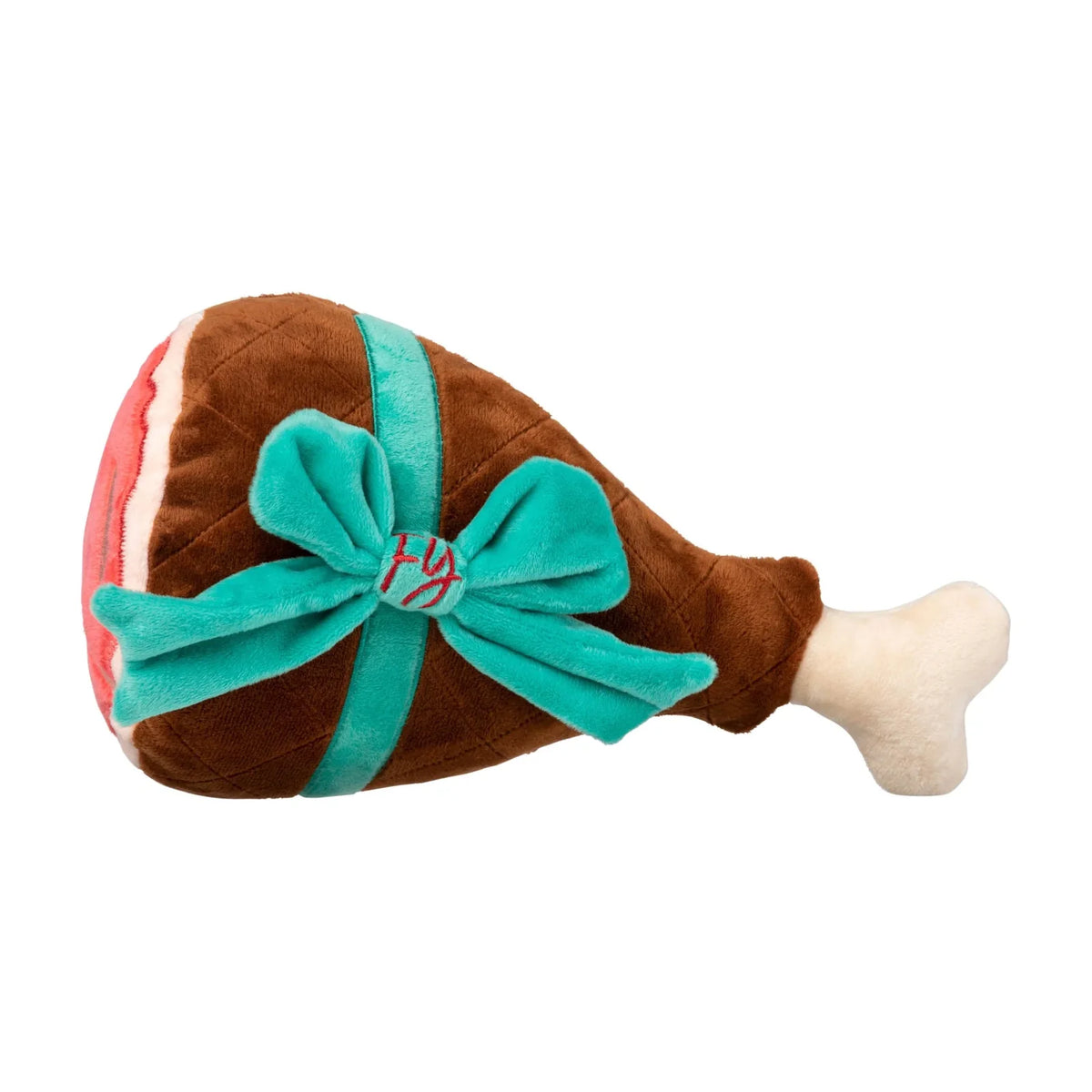 A FuzzYard Humongous Holiday Ham plush Christmas dog toy, made of brown and cream fabric with a bright teal velvet bow wrapped around it, shown on a plain white background.