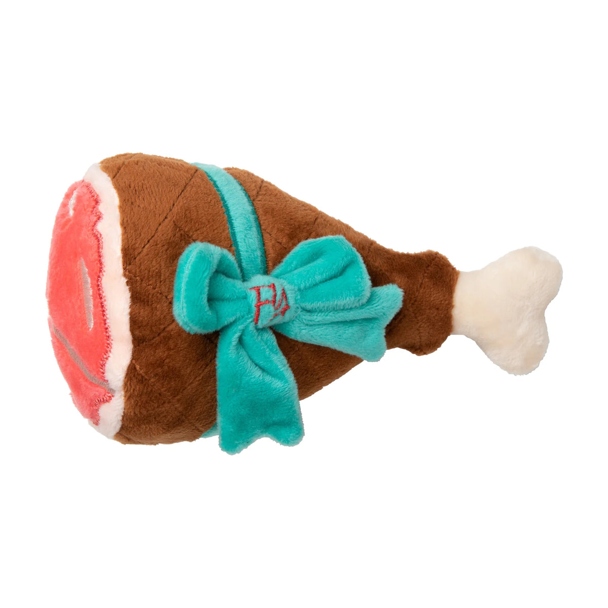 A FuzzYard Humongous Holiday Ham  Christmas dog toy, featuring brown plush fabric, a bright turquoise ribbon and bow with red embroidered initials, and a pink-and-white stuffed head, set against a plain white background.