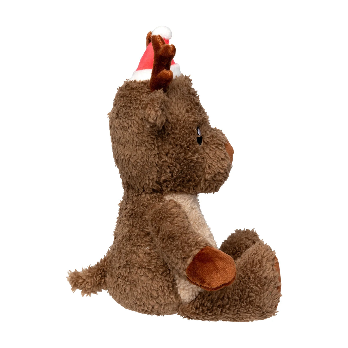 A FuzzYard Ralph The Reindeer plush Christmas dog toy sitting down, wearing a red and white Santa hat, isolated on a white background.