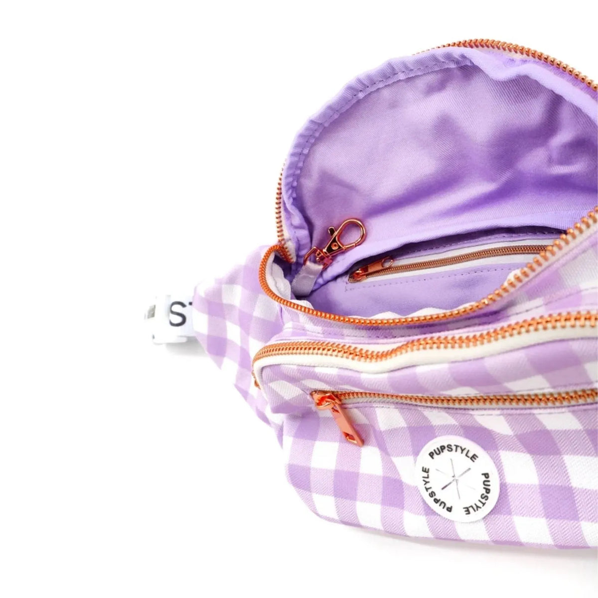 A close-up of a Pupstyle Berry Milkshake Dog Parent Bum Bag with rose gold zippers and a purple satin lining, showing the interior compartments and a poop bag dispensor.